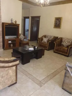 a large living room with couches and a television at Furnished apartment for rent in Amman