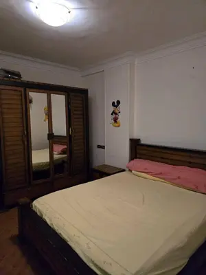 a bedroom with a bed with a mickey mouse sticker on the wall at Tree apartment in Amman