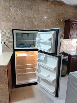 a refrigerator with its door open in a kitchen at الشقة الفاخرة الحديثة in Amman