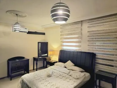 a bedroom with a bed and a table and a mirror at Red Sea Pearl Luxury Villa in Aqaba in Aqaba