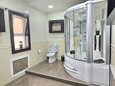 a bathroom with a shower and a toilet at Red Sea Pearl Luxury Villa in Aqaba in Aqaba