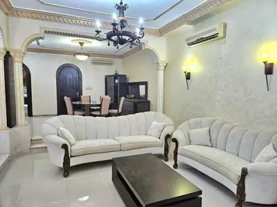 a living room with two white couches and a table at Red Sea Pearl Luxury Villa in Aqaba in Aqaba