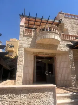 a building with a balcony on top of it at Red Sea Pearl Luxury Villa in Aqaba in Aqaba