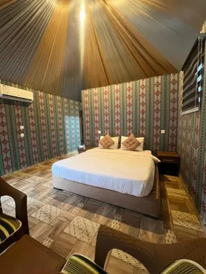 a bedroom with a bed in a room at RUM PILLARS REST houstl in Wadi Rum