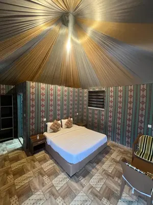 a bedroom with a bed in a tent at RUM PILLARS REST houstl in Wadi Rum