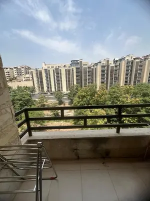 a balcony with a view of a city with tall buildings at عبدون الشمالي in Amman
