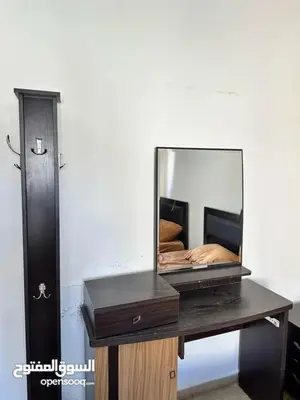a mirror sitting on a desk with a dresser at studio al jubiha 1 استوديو الجبيهة in Amman