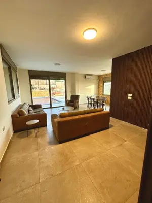 a living room with a couch and a table at sama vailla in Amman