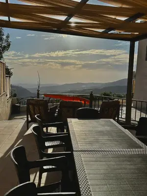 a table and chairs on a balcony with a view at sama vailla in Amman