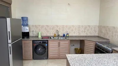 a kitchen with a refrigerator and a washing machine at شالية جوهرة جراسيا Jewel of Gracia Chalet in Jerash