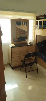 a room with a desk with a chair and a mirror at العقبه in Aqaba