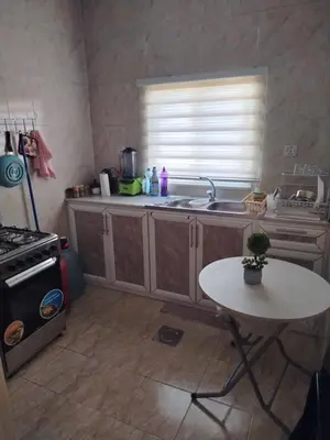 a kitchen with a sink and a table in it at العقبه in Aqaba