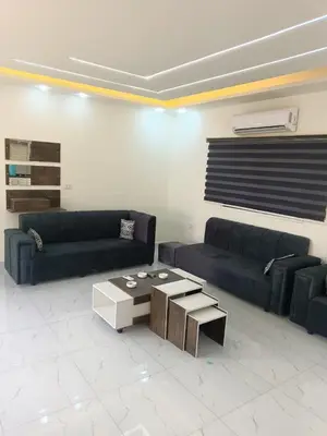 a living room with two couches and a coffee table at شاليه ومزرعة طبقة فحل Chalet Pella