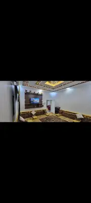 a large room with a television and a wall at شقة مفروشة للإجار in Ar Ramthā