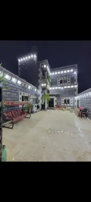 a large building with a parking lot in front of it at شقة مفروشة للإجار in Ar Ramthā