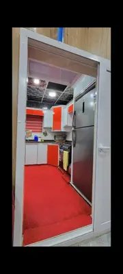 an open door to a kitchen with a red carpet at شقة مفروشة للإجار in Ar Ramthā