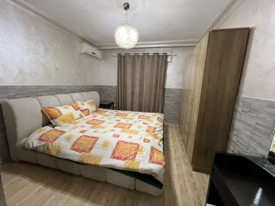 a bedroom with a bed with a quilt on it at Central affordable studio in Amman