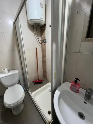 a small bathroom with a toilet and a sink at Central affordable studio in Amman