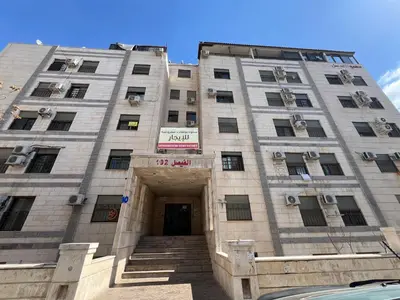 a tall building with a sign on it at Central affordable studio in Amman