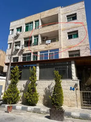 a brick building with trees in front of it at Central affordable studio in Amman