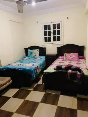a bedroom with two beds and a checkered floor at اهلا وسهلا في الاردن in Petra