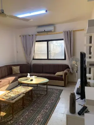 a living room with a couch and a table at Affordable Furnished 2BR for Rent in Amman