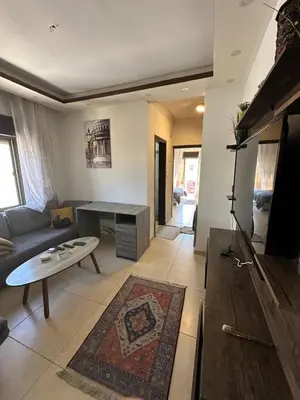a living room with a couch and a table at MK5 - One bedroom Apartment in Amman