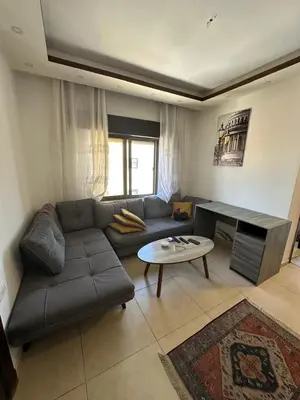 a living room with a couch and a table at MK5 - One bedroom Apartment in Amman