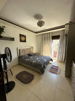 a bedroom with a bed in a room with a window at MK5 - One bedroom Apartment in Amman