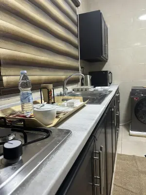 a kitchen with a sink and a counter top at EVANNA SUITE & HOTELs VIP ايفانا للشقق الفندقيه VIP in Amman