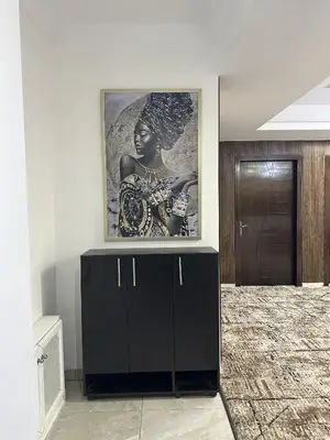 a black cabinet in a room with a picture on the wall at EVANNA SUITE & HOTELs VIP ايفانا للشقق الفندقيه VIP in Amman