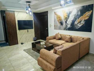a living room with a couch and a flat screen tv at EVANNA SUITE & HOTELs VIP ايفانا للشقق الفندقيه VIP in Amman