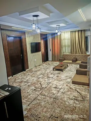 a large living room with a couch and a television at EVANNA SUITE & HOTELs VIP ايفانا للشقق الفندقيه VIP in Amman