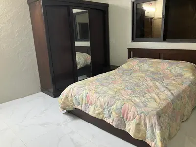 a bedroom with a bed and a dresser and a mirror at Kenda house in Ajloun