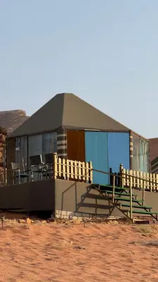 a building with a porch and chairs in front of it at LUXURY camp in Disah