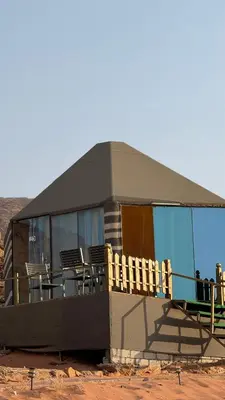 a house with a deck and chairs in front of it at LUXURY camp in Disah