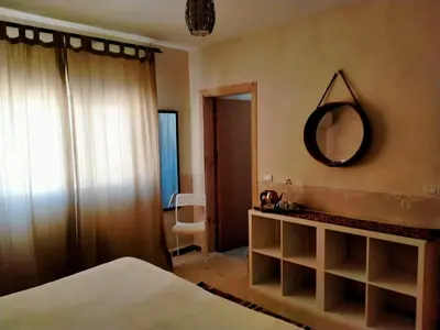 a bedroom with a bed and a mirror on the wall at B&B petrafarmhouse in Wadi Musa