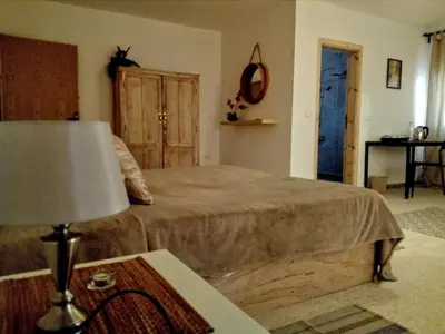a bedroom with a bed and a table with a lamp at B&B petrafarmhouse in Wadi Musa