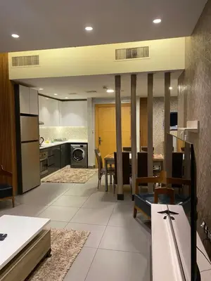 a kitchen and dining room with a table and chairs at Luxury one bedroom in DAMAC in Amman