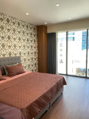 a bedroom with a bed and a large window at Luxury one bedroom in DAMAC in Amman