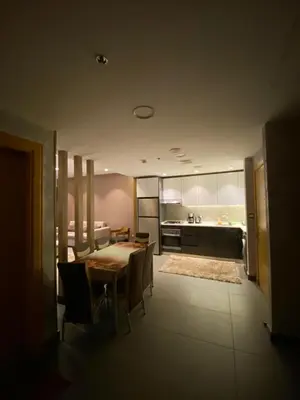a kitchen and dining room with a table and chairs at Luxury one bedroom in DAMAC in Amman