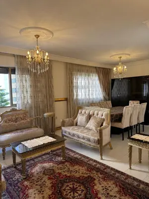 a living room with a couch and a table at Comfort Apartment in Amman