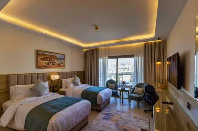 a hotel room with two beds and a television at Petra Legacy Luxury in Petra