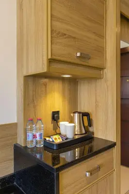 a kitchen counter with a tea kettle and water bottles at Petra Legacy Luxury in Petra