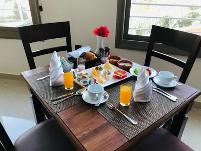 a table with a breakfast of food and orange juice at Petra Legacy Luxury in Petra