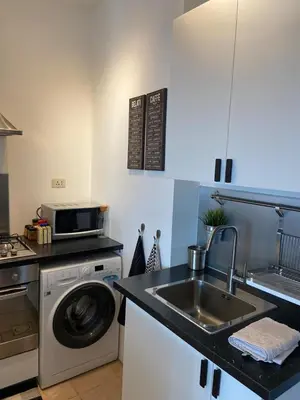 a kitchen with a sink and a washing machine at Studio for Rent in Jabal Alweibdeh-Amman - Jordan in Amman