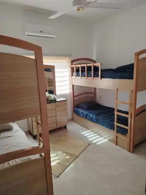 a room with two bunk beds and a desk at العقبه in Aqaba