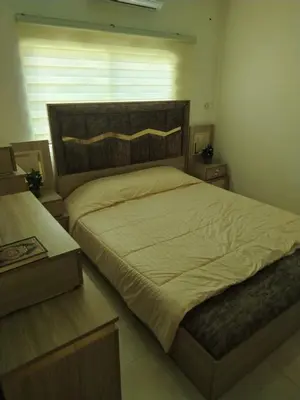 a bedroom with a large bed and a window at العقبه in Aqaba