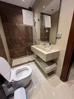 a bathroom with a toilet and a sink at Amman Central Comfort in Amman