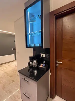 a room with a flat screen tv on a wall at Amman Central Comfort in Amman